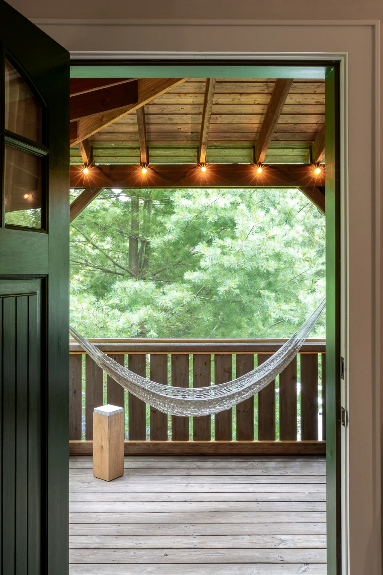 An open doorway looking out to the porch and hammock
