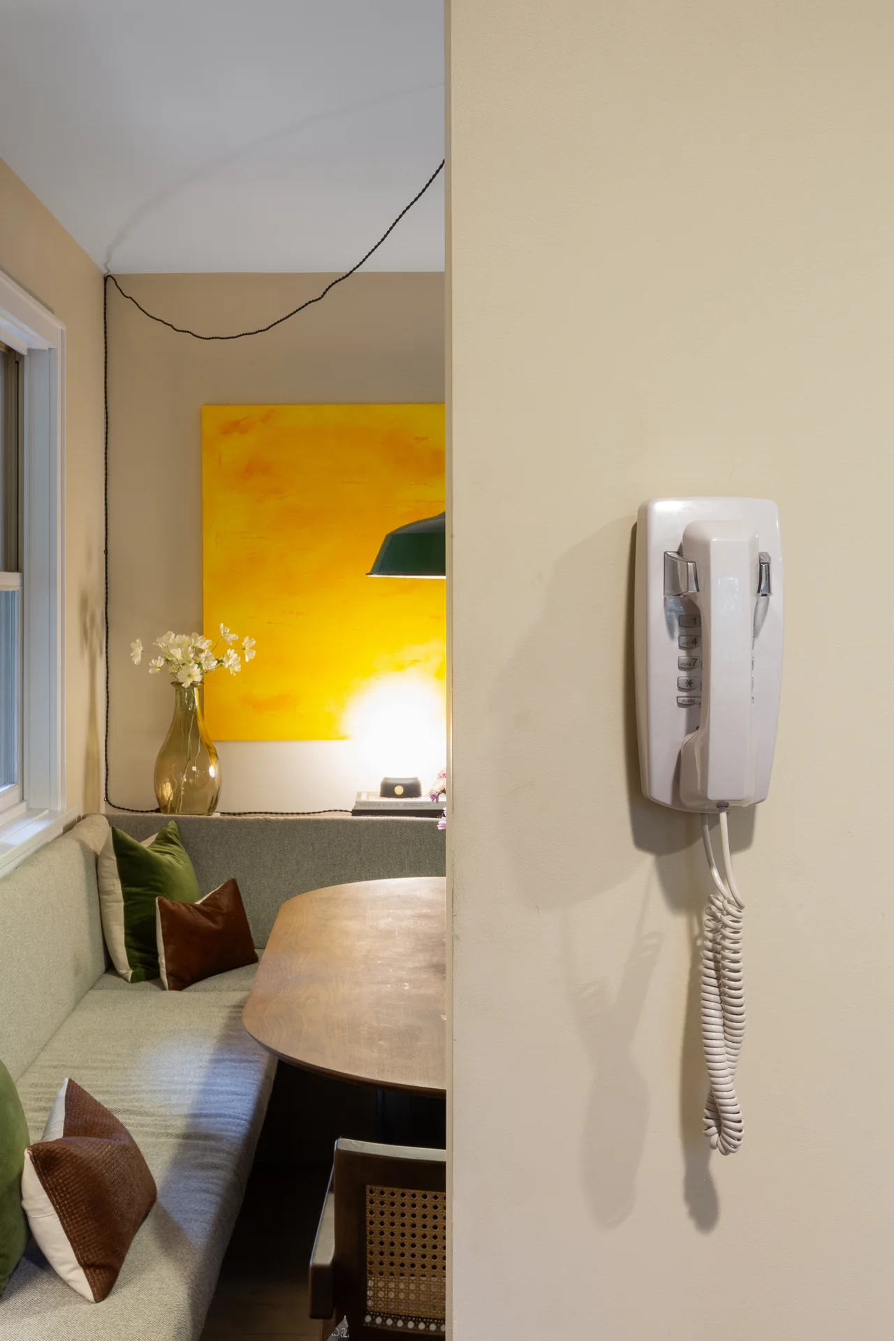A view into the dining room with a yellow painting