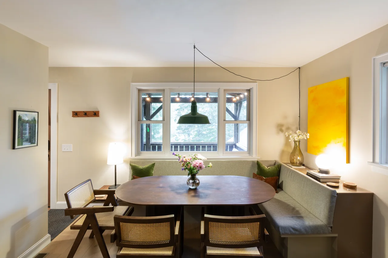 Dining nook with a round wooden table and built-in seating