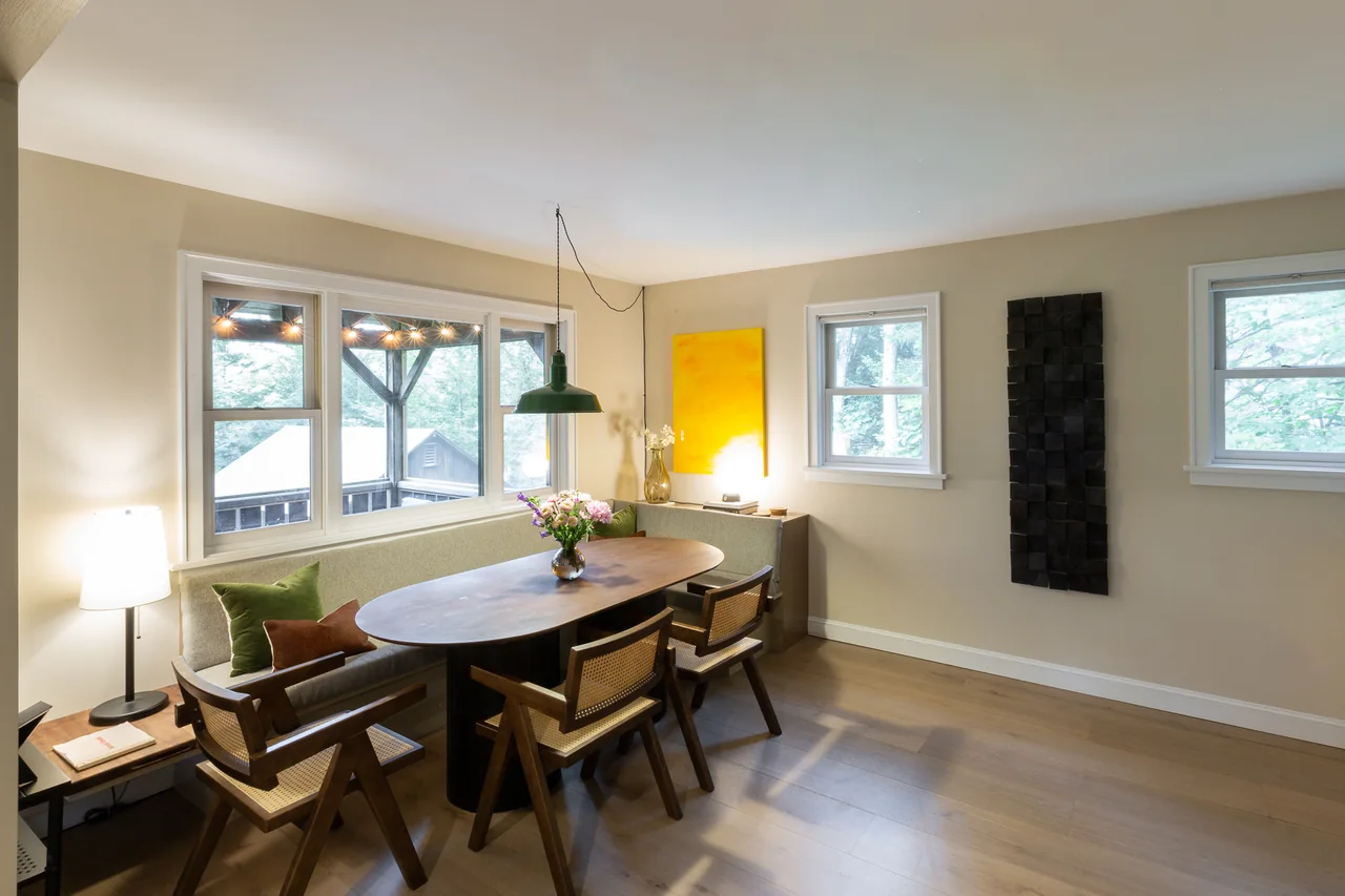 Dining area with a yellow painting and garden views