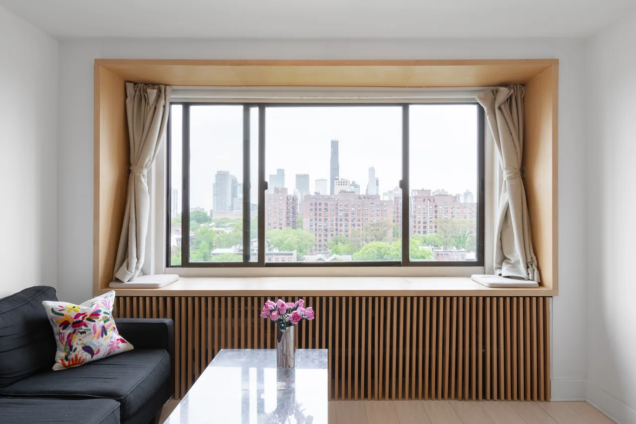 A timber-framed window seat overlooking the skyline at Clinton Hill Apartment