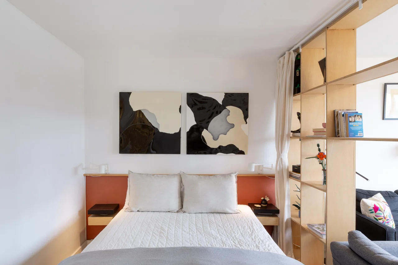 Sleeping area with timber shelving and graphic artwork