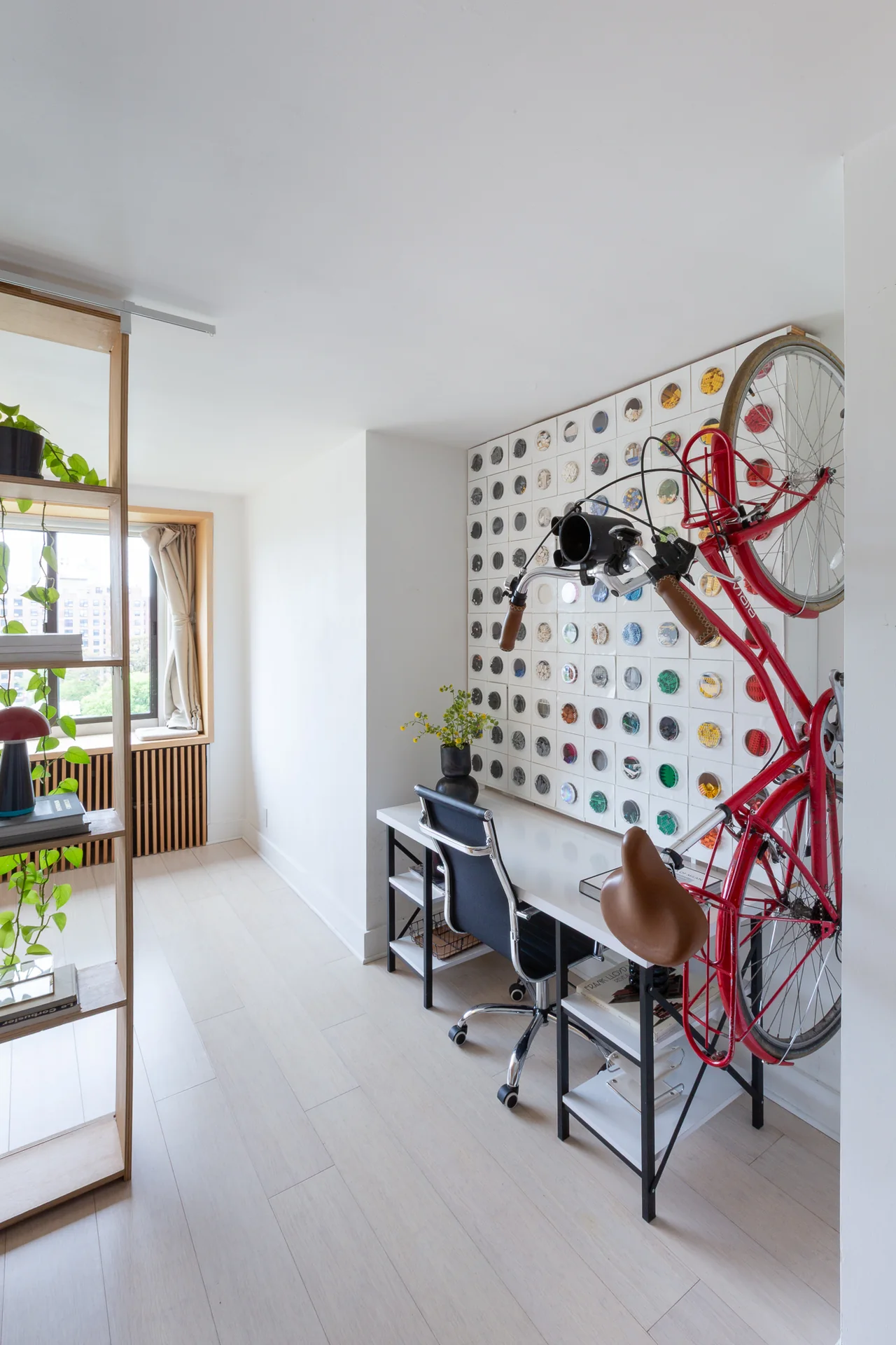 Wall storage for a bicycle beside an open workspace