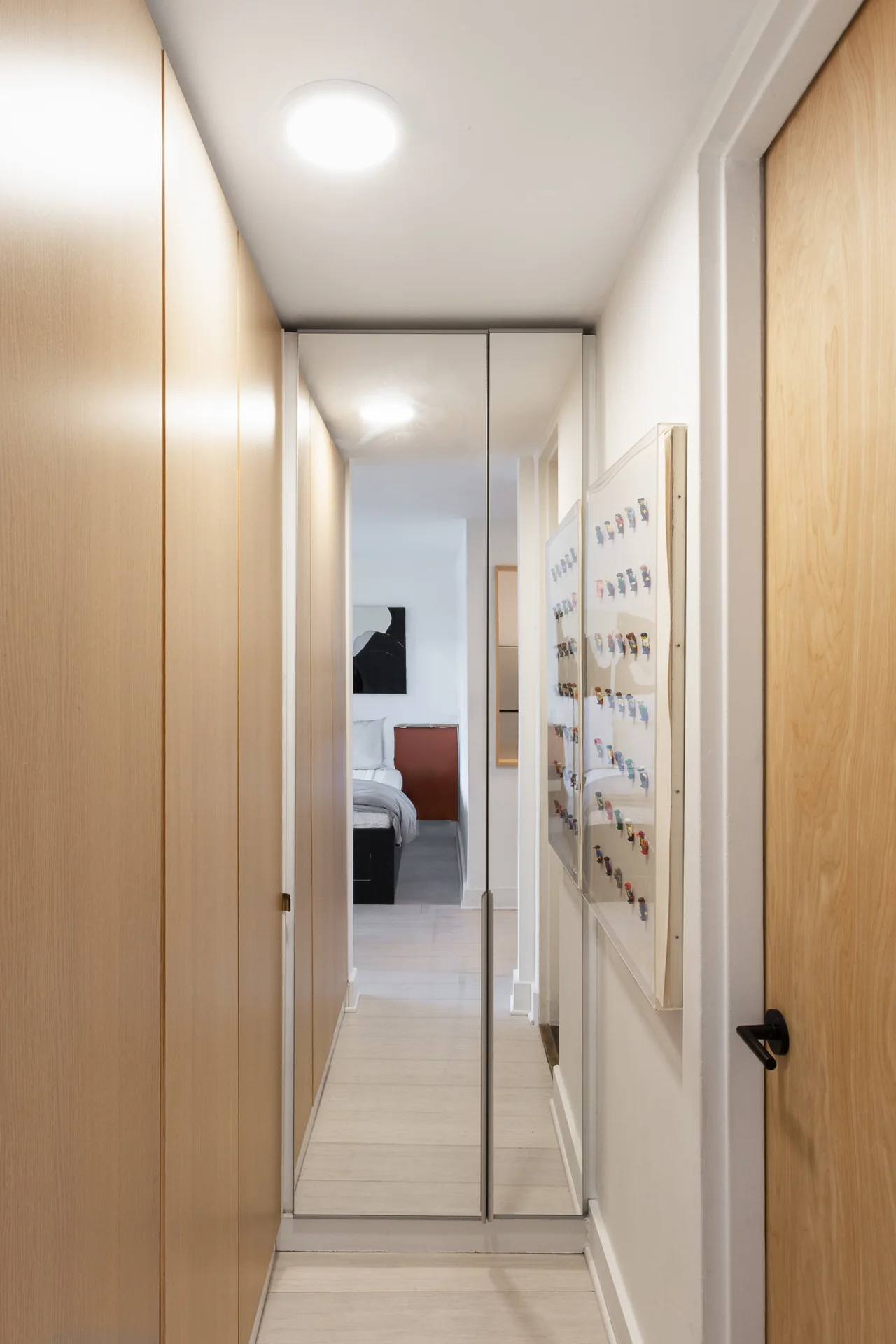 A hallway lined with full-height timber storage