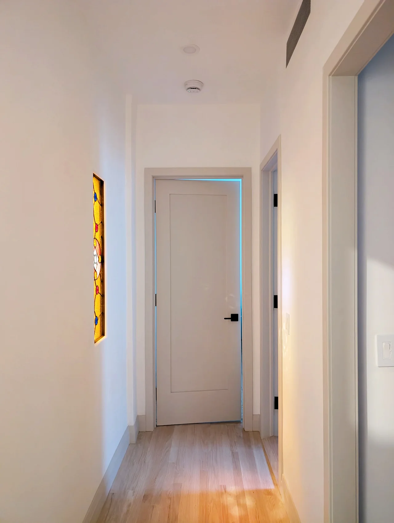 A light-filled hallway with warm timber flooring