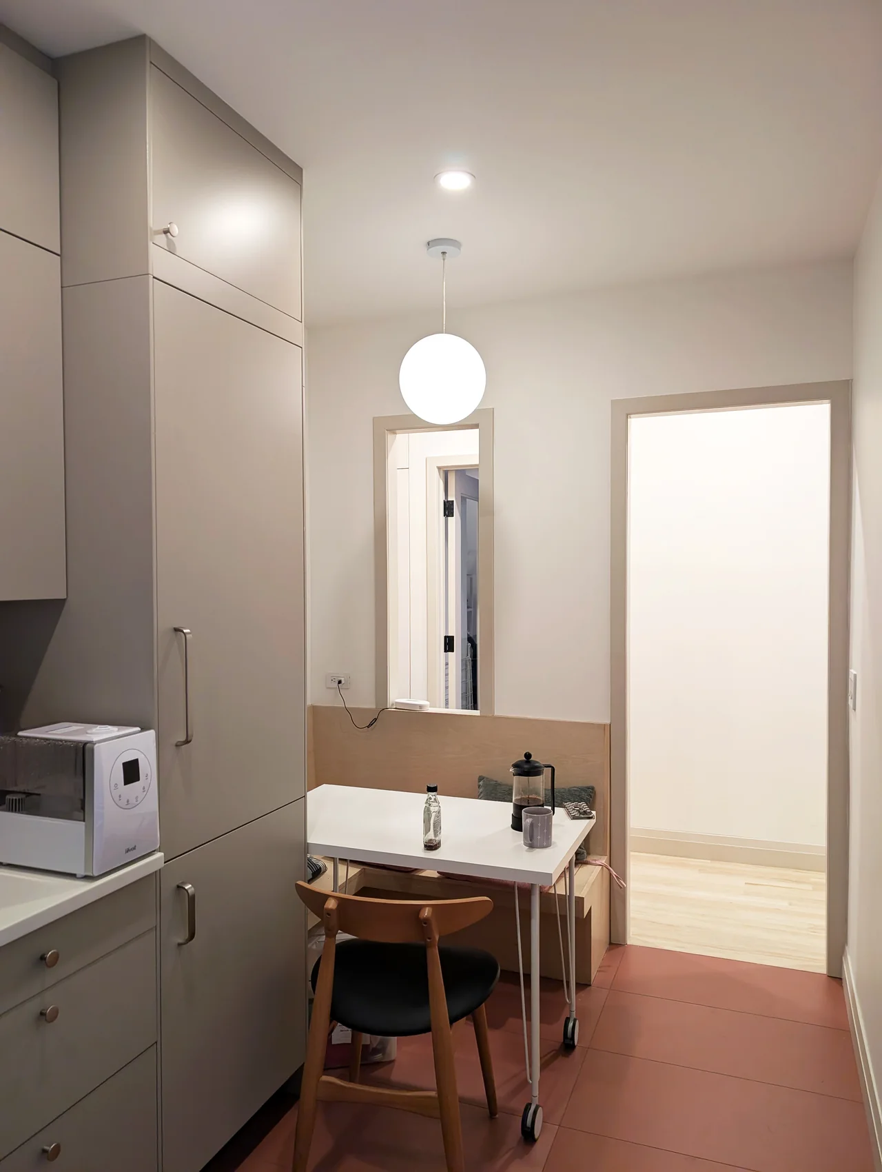 A compact dining nook with full-height cabinetry