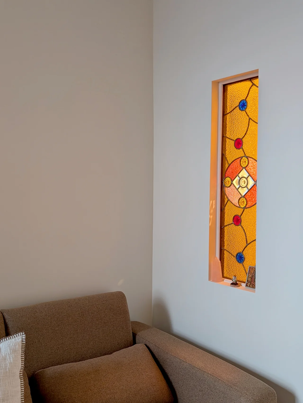 A living room detail with a warm yellow artwork